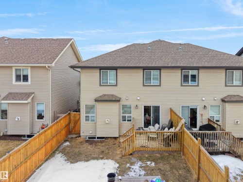Snow covered house featuring a shingled roof, a wooden deck, and a fenced backyard - 1659 Hammond Crescent, Edmonton, AB - Outdoor With Exterior