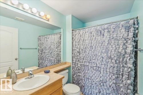 Bathroom featuring vanity and curtained shower - 112 5340 199 Street, Edmonton, AB - Indoor Photo Showing Bathroom