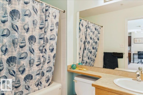 Bathroom with vanity and shower / bath combination with curtain - 112 5340 199 Street, Edmonton, AB - Indoor Photo Showing Bathroom