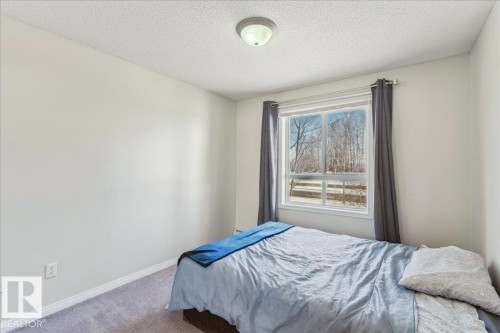 Bedroom featuring carpet floors and a textured ceiling - 112 5340 199 Street, Edmonton, AB - Indoor Photo Showing Bedroom