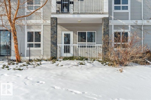 View of snow covered property entrance - 112 5340 199 Street, Edmonton, AB - Outdoor With Facade