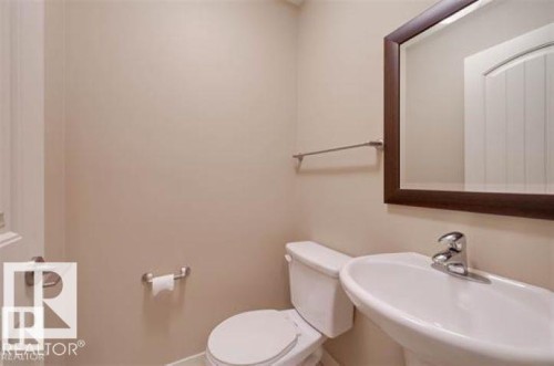 Bathroom featuring toilet and a sink - 1649 Cunningham Way, Edmonton, AB - Indoor Photo Showing Bathroom