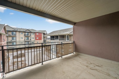 This property features a balcony with a concrete floor and a dark metal railing - 1649 Cunningham Way, Edmonton, AB - Outdoor With Balcony With Exterior