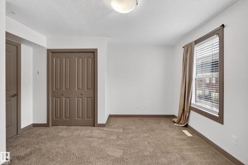 This room features plush carpeting and white walls, offering a neutral palette - 1649 Cunningham Way, Edmonton, AB - Indoor Photo Showing Other Room