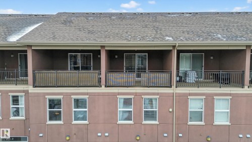 The property features multiple balconies with dark railings, providing outdoor space - 1649 Cunningham Way, Edmonton, AB - Outdoor With Balcony