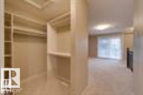 View of walk in closet - 1649 Cunningham Way, Edmonton, AB - Indoor Photo Showing Other Room