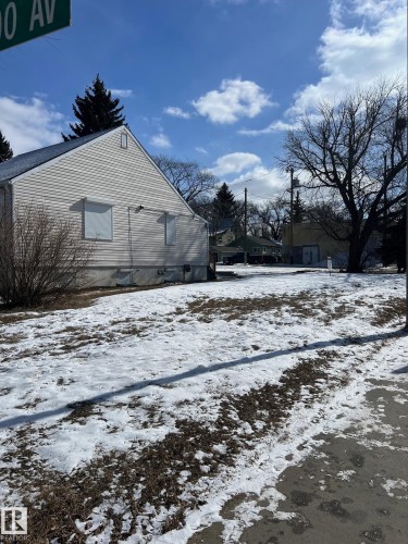 The property features white vinyl siding and a dark shingle roof - 8915 99 Street Nw, Edmonton, AB 
