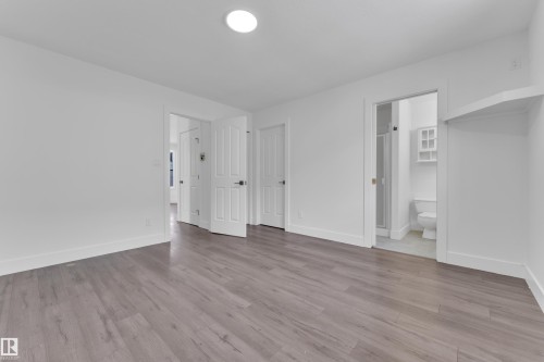 Unfurnished bedroom with light wood finished floors and ensuite bath - 6741 162A Avenue, Edmonton, AB - Indoor Photo Showing Other Room