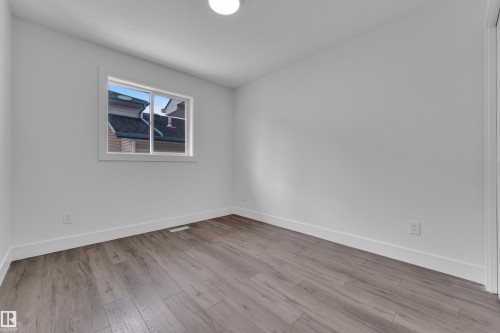 Unfurnished room featuring baseboards and light wood-style floors - 6741 162A Avenue, Edmonton, AB - Indoor Photo Showing Other Room