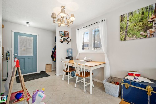 Office area with light tile patterned floors and a chandelier - 9221 84 Street, Fort Saskatchewan, AB - Indoor Photo Showing Dining Room
