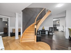 Stairs with wainscoting, hardwood / wood-style floors, and a textured ceiling - 