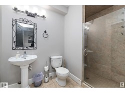 Bathroom featuring a stall shower and light tile patterned floors - 