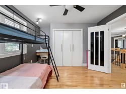 Bedroom with a closet, light wood-style floors, and ceiling fan - 