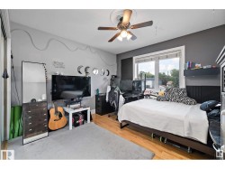 Bedroom with light wood-style floors and a ceiling fan - 