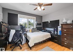 Bedroom featuring light wood-type flooring and a ceiling fan - 
