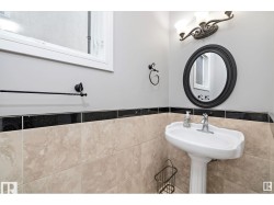 Bathroom featuring tile walls and a wainscoted wall - 