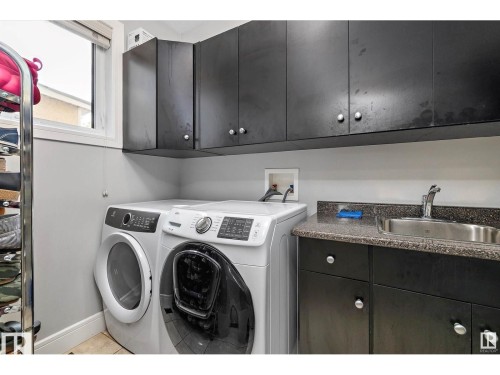 Laundry area with washer and dryer and cabinet space - 9544 154 Street, Edmonton, AB 