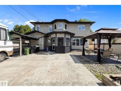 View of front of property featuring a gazebo, a patio, stucco siding, and a sunroom - 