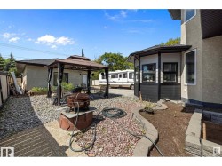 Fenced backyard featuring a gazebo, an outdoor fire pit, and a patio - 