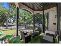 Fenced backyard with a playground, a patio area, and an outdoor living space - 
