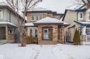 View of front of home featuring stone siding and roof with shingles - 2224 Austin Way, Edmonton, AB  - Outdoor With Facade 