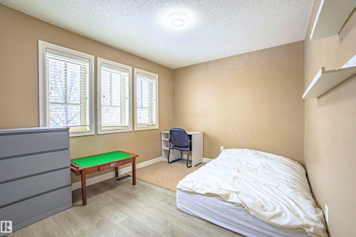 Bedroom featuring light wood-type flooring and a textured ceiling - 2224 Austin Way, Edmonton, AB - Indoor Photo Showing Bedroom