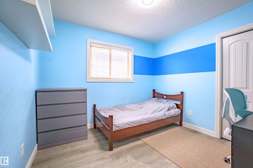 Bedroom with a textured ceiling and wood finished floors - 2224 Austin Way, Edmonton, AB - Indoor Photo Showing Bedroom