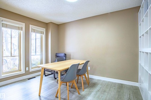 Dining area featuring a textured ceiling and light wood-style flooring - 2224 Austin Way, Edmonton, AB - Indoor Photo Showing Dining Room