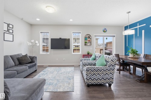 Living room with dark wood-type flooring and recessed lighting - 5112 Andison Close, Edmonton, AB - Indoor Photo Showing Living Room