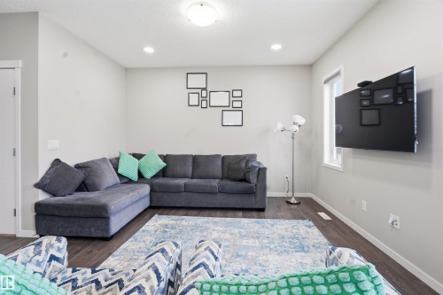 Living room featuring dark wood finished floors and recessed lighting - 5112 Andison Close, Edmonton, AB - Indoor Photo Showing Living Room