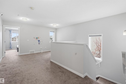 Hallway with an upstairs landing and light colored carpet - 5112 Andison Close, Edmonton, AB - Indoor Photo Showing Other Room