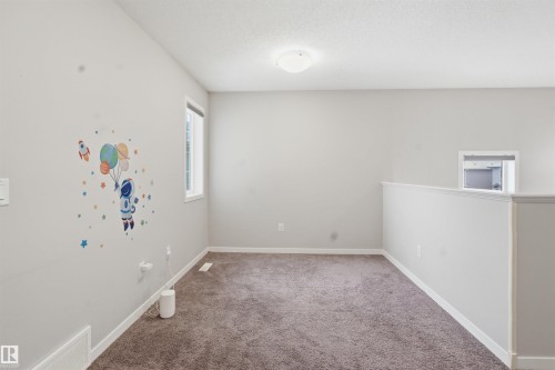 Carpeted empty room featuring baseboards - 5112 Andison Close, Edmonton, AB - Indoor Photo Showing Other Room