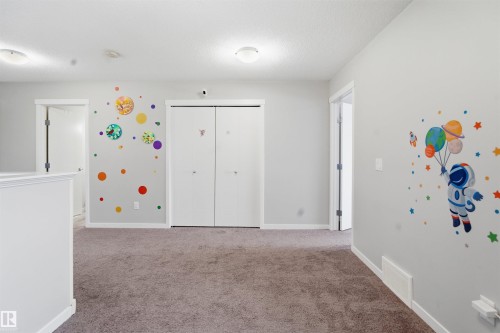 Unfurnished bedroom with light carpet and a closet - 5112 Andison Close, Edmonton, AB - Indoor Photo Showing Other Room