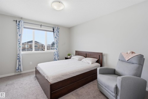 Carpeted bedroom featuring baseboards - 5112 Andison Close, Edmonton, AB - Indoor Photo Showing Bedroom