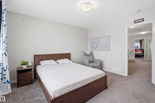 Bedroom featuring light carpet and baseboards - 5112 Andison Close, Edmonton, AB - Indoor Photo Showing Bedroom