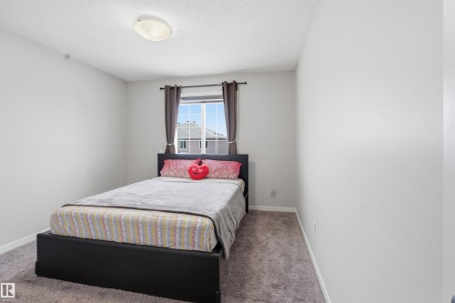 Carpeted bedroom with baseboards - 5112 Andison Close, Edmonton, AB - Indoor Photo Showing Bedroom