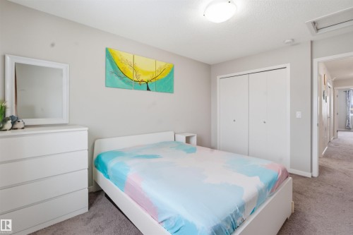 Bedroom with light colored carpet and a closet - 5112 Andison Close, Edmonton, AB - Indoor Photo Showing Bedroom