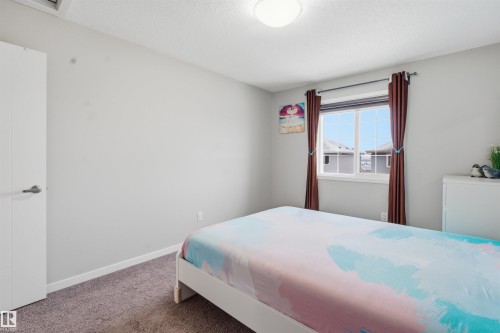 Bedroom featuring dark colored carpet and a textured ceiling - 5112 Andison Close, Edmonton, AB - Indoor Photo Showing Bedroom