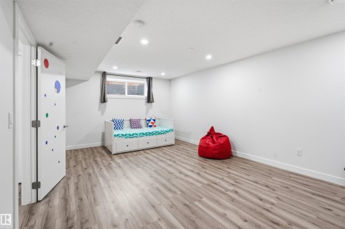 Recreation room featuring light wood-style floors and recessed lighting - 5112 Andison Close, Edmonton, AB - Indoor
