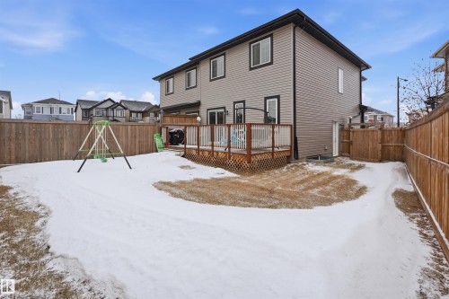 Snow covered property with a deck, a fenced backyard, and a residential view - 5112 Andison Close, Edmonton, AB - Outdoor