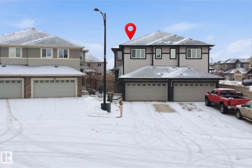 View of front of home with an attached garage and a shingled roof - 5112 Andison Close, Edmonton, AB - Outdoor With Facade