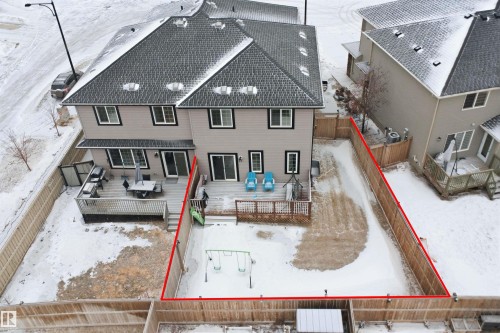 Snow covered rear of property with a deck, a fenced backyard, and roof with shingles - 5112 Andison Close, Edmonton, AB - Outdoor With Exterior