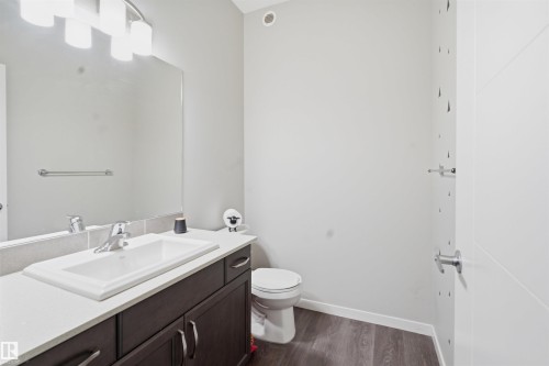 Half bath featuring vanity and dark wood finished floors - 5112 Andison Close, Edmonton, AB - Indoor Photo Showing Bathroom