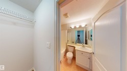 Bathroom with a textured ceiling, vanity, shower / bath combo, and light tile patterned floors - 
