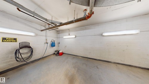Garage with concrete block wall - 115 9938 104 St, Edmonton, AB - Indoor Photo Showing Garage