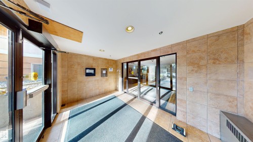 Common area featuring tile walls and recessed lighting - 115 9938 104 St, Edmonton, AB - Indoor Photo Showing Other Room
