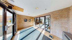 Common area featuring tile walls and recessed lighting - 