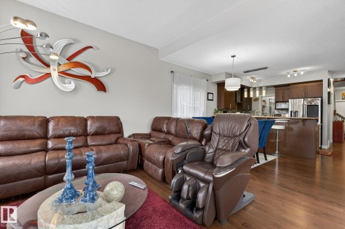 Living room with dark wood-style floors, a textured ceiling, and track lighting - 21867 80 Avenue, Edmonton, AB - Indoor Photo Showing Living Room