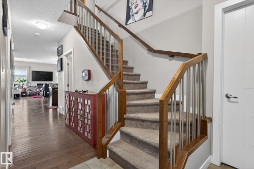Staircase featuring a textured ceiling and wood-type flooring - 21867 80 Avenue, Edmonton, AB - Indoor Photo Showing Other Room