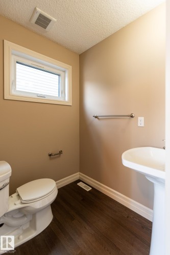 Bathroom featuring dark wood-style floors and a textured ceiling - 1118 162 Street, Edmonton, AB - Indoor Photo Showing Bathroom